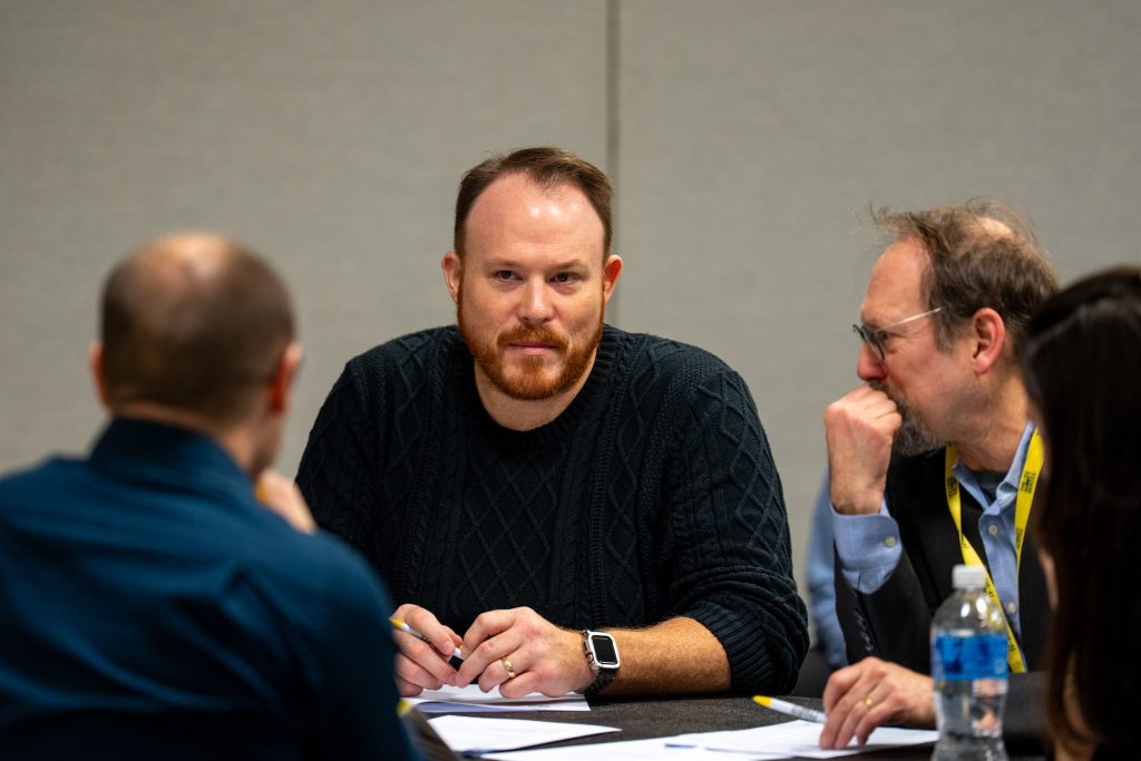 A man focused on what they are explaining at the event.
